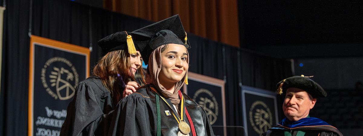 Honors student on stage at commencement.