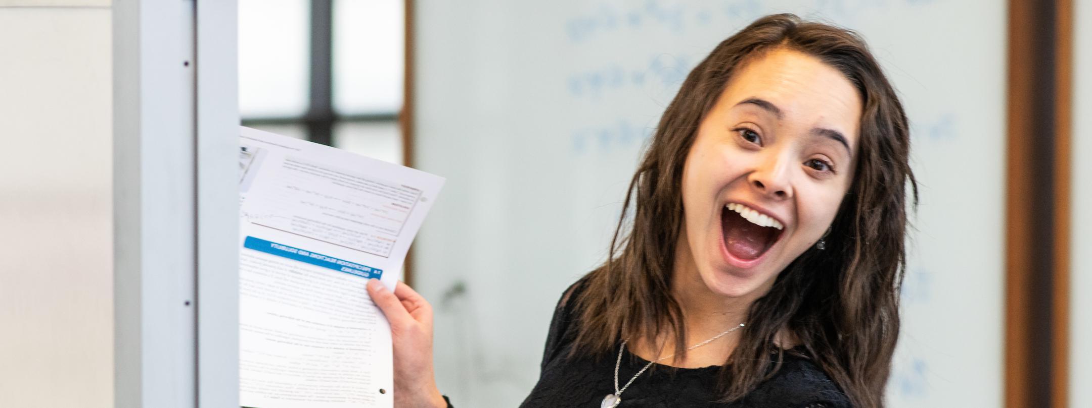 Student smiles for the camera while studying.